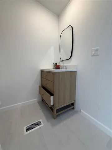 a room with a bed and a mirror