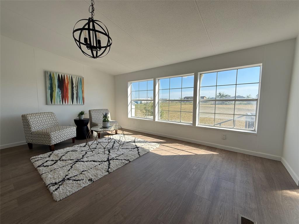 835 Private Road 4732 Rhome, TX 76078 - Photo 9 of 30 a living room with furniture large window and wooden floor