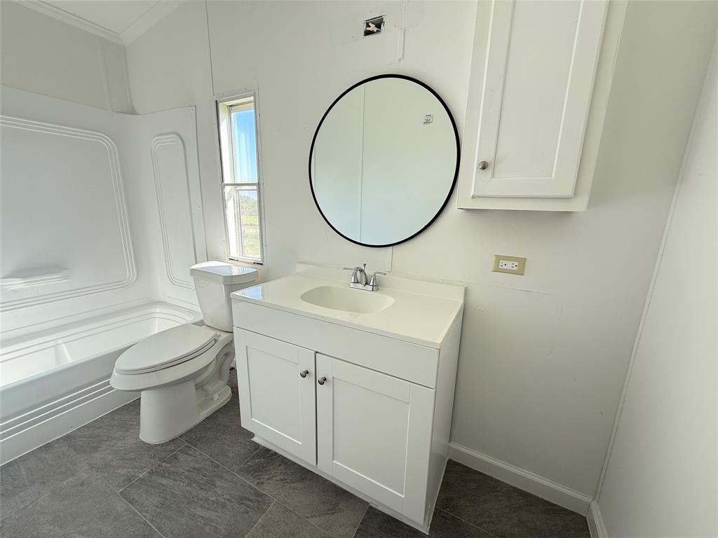 835 Private Road 4732 Rhome, TX 76078 - Photo 10 of 30 a bathroom with a sink a toilet and a mirror