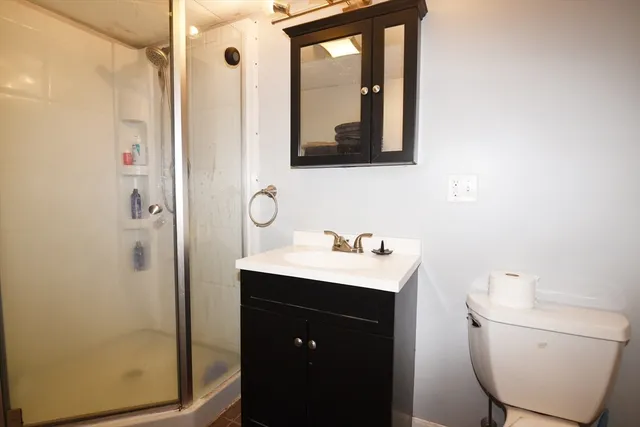 a bathroom with a toilet sink and mirror