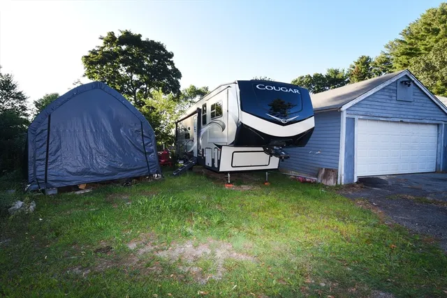 a backyard of a house with table and chairs