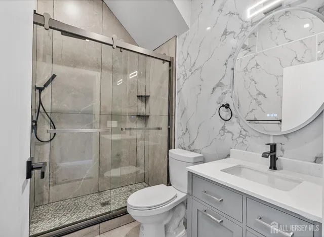 a bathroom with a sink toilet and shower