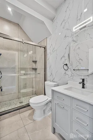 a bathroom with a sink toilet and shower