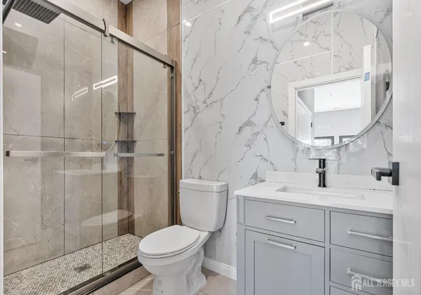 a bathroom with a sink toilet and shower