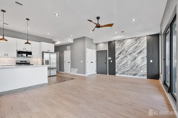 a view of a kitchen with wooden floor