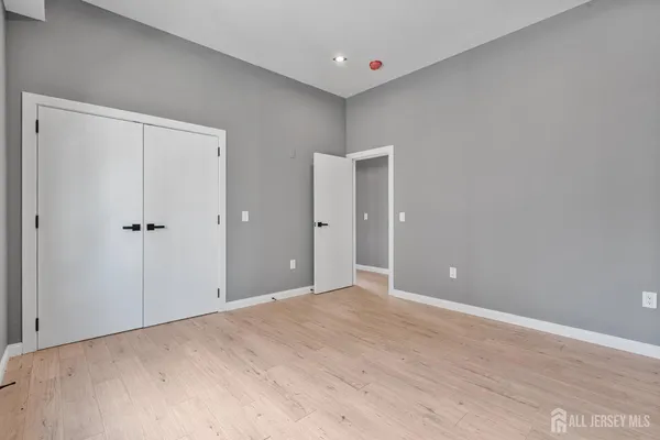 a view of a big room with closet and chandelier fan