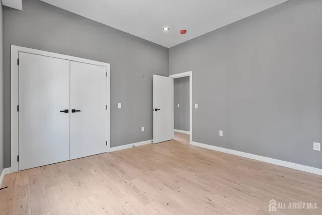 a view of a big room with closet and chandelier fan