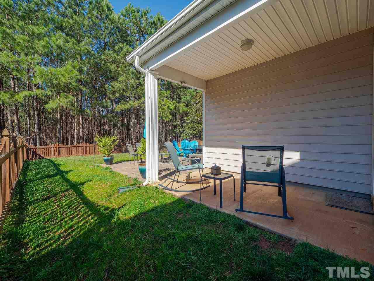 8429 Whisper Ridge Place Raleigh, NC 27613 - Photo 22 of 27 Past the sliding glass doors, enjoy the covered side patio area