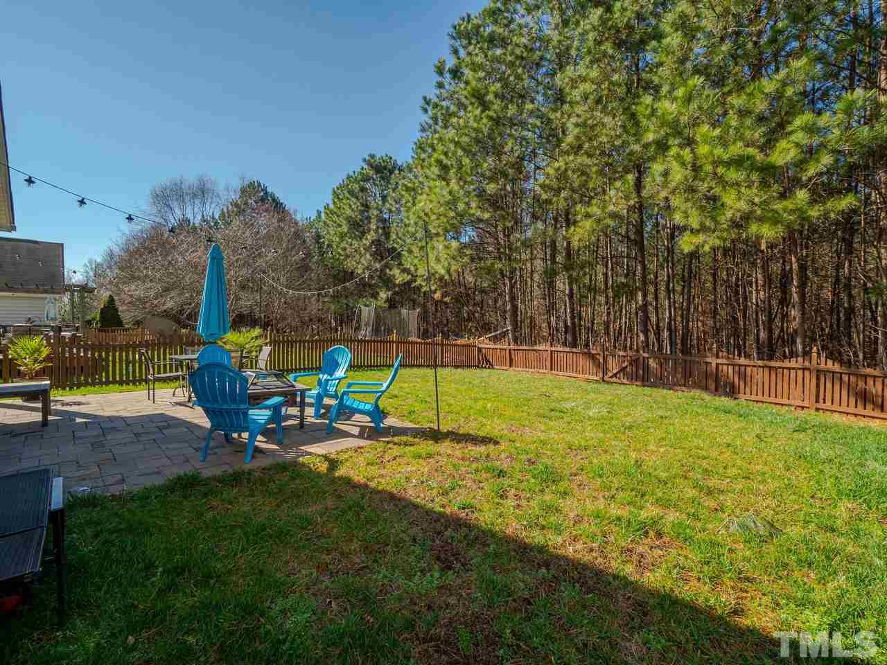 8429 Whisper Ridge Place Raleigh, NC 27613 - Photo 25 of 27 The fully fenced backyard is nicely level and backs to a beautiful common, wooded area.