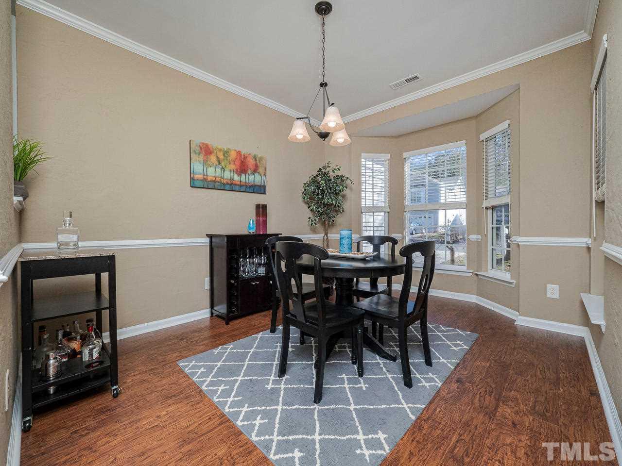 8429 Whisper Ridge Place Raleigh, NC 27613 - Photo 4 of 27 Large Dining room with Bump out Bay window and pass through into Kitchen