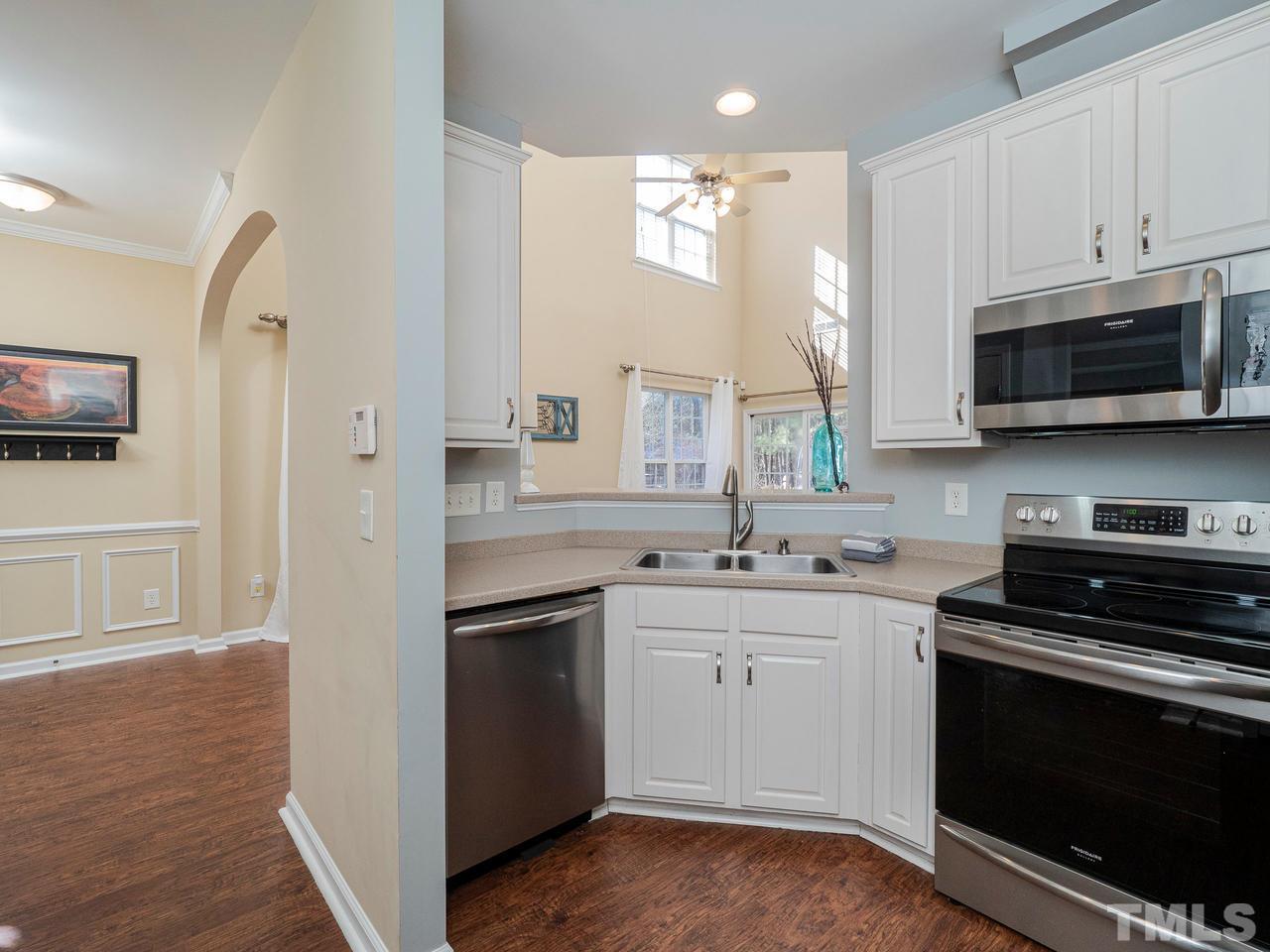 8429 Whisper Ridge Place Raleigh, NC 27613 - Photo 8 of 27 Kitchen features updated appliances and Solid Surface countertops, large pantry and access to 1-car garage