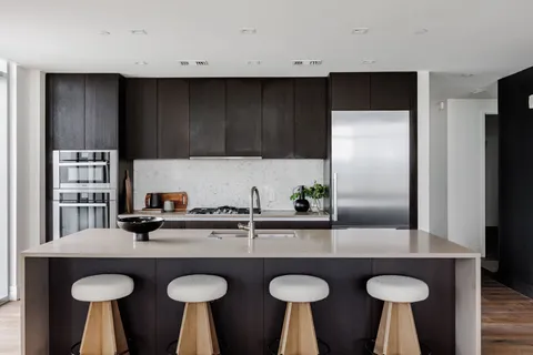 a kitchen with furniture a sink and a refrigerator