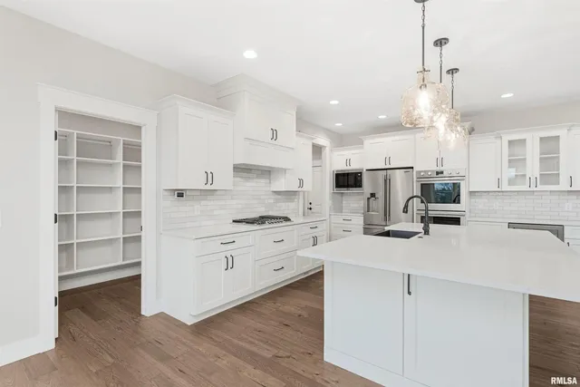 a kitchen with kitchen island white cabinets and white appliances