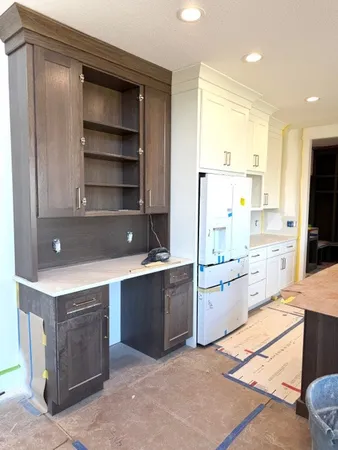a kitchen with a refrigerator sink and cabinets