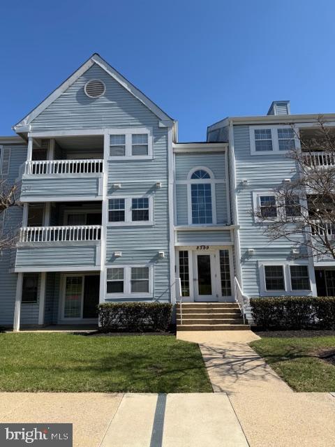 8399 Montgomery Run Road, Unit I Ellicott City, MD 21043 - Photo 1 of 26 a front view of a house with a yard