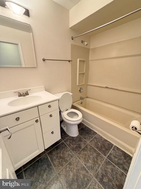 8399 Montgomery Run Road, Unit I Ellicott City, MD 21043 - Photo 14 of 26 a bathroom with a white toilet sitting next to a bathroom sink and a shower
