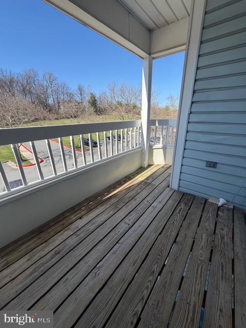 8399 Montgomery Run Road, Unit I Ellicott City, MD 21043 - Photo 23 of 26 a view of a balcony with wooden floor and fence