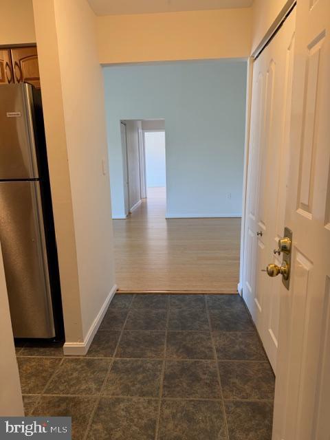 8399 Montgomery Run Road, Unit I Ellicott City, MD 21043 - Photo 3 of 26 a view of a hallway with wooden floor and a glass door