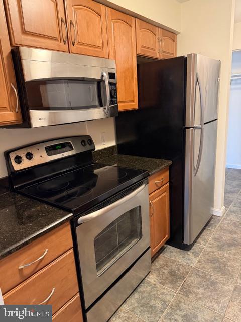8399 Montgomery Run Road, Unit I Ellicott City, MD 21043 - Photo 9 of 26 a kitchen with granite countertop white cabinets and stainless steel appliances