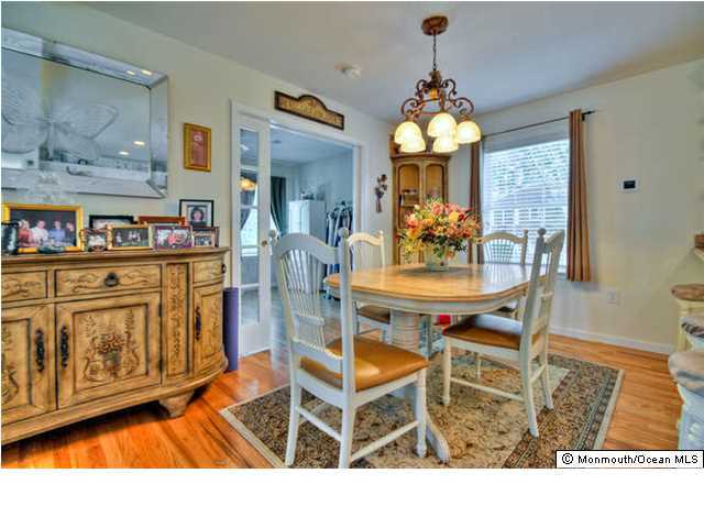 2100 Old Mill Road Spring Lake Heights, NJ 07762 - Photo 8 of 20 a view of a dining room with furniture and chandelier