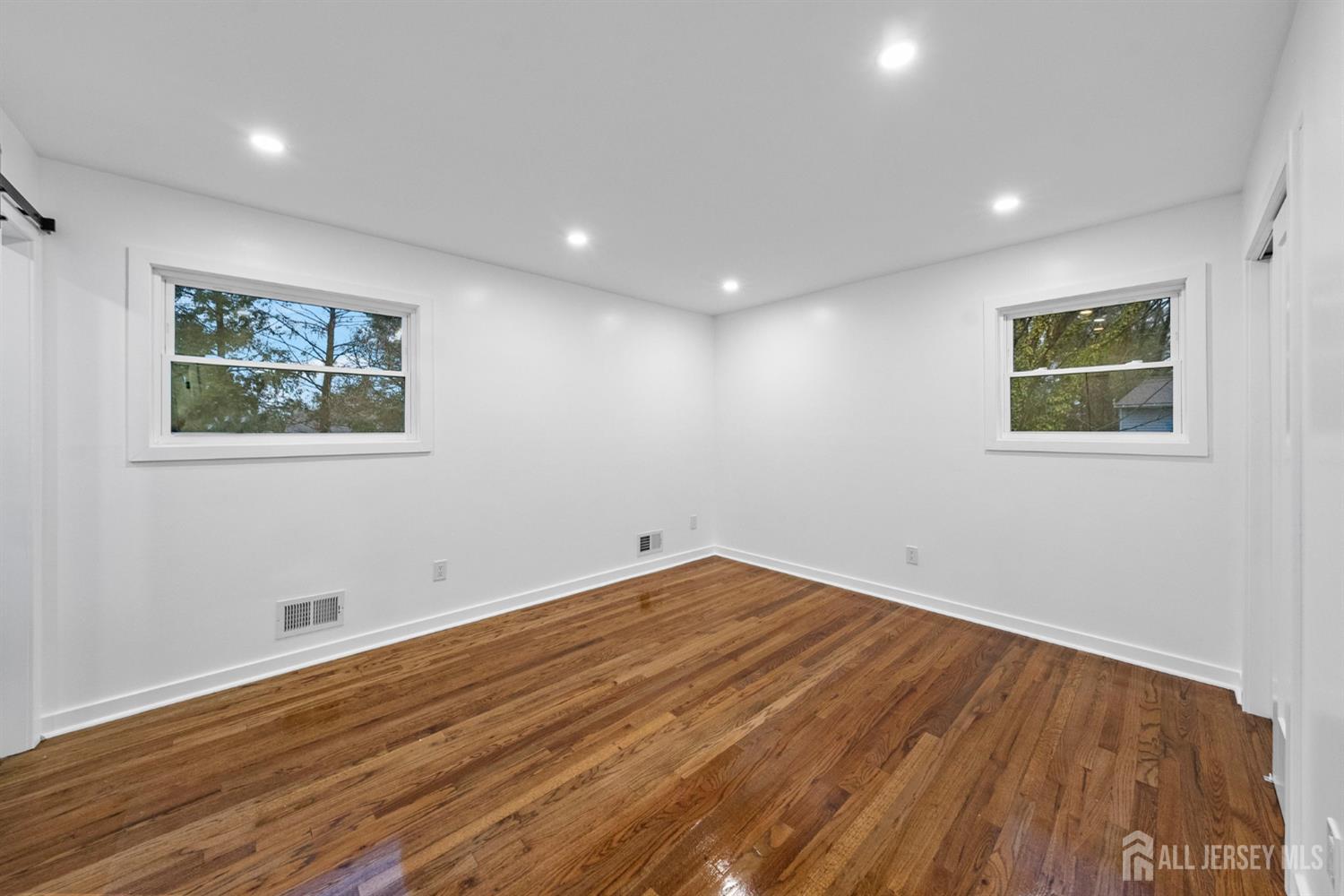 12 Barker Road Somerset, NJ 08873 - Photo 30 of 43 a view of empty room with wooden floor and fan