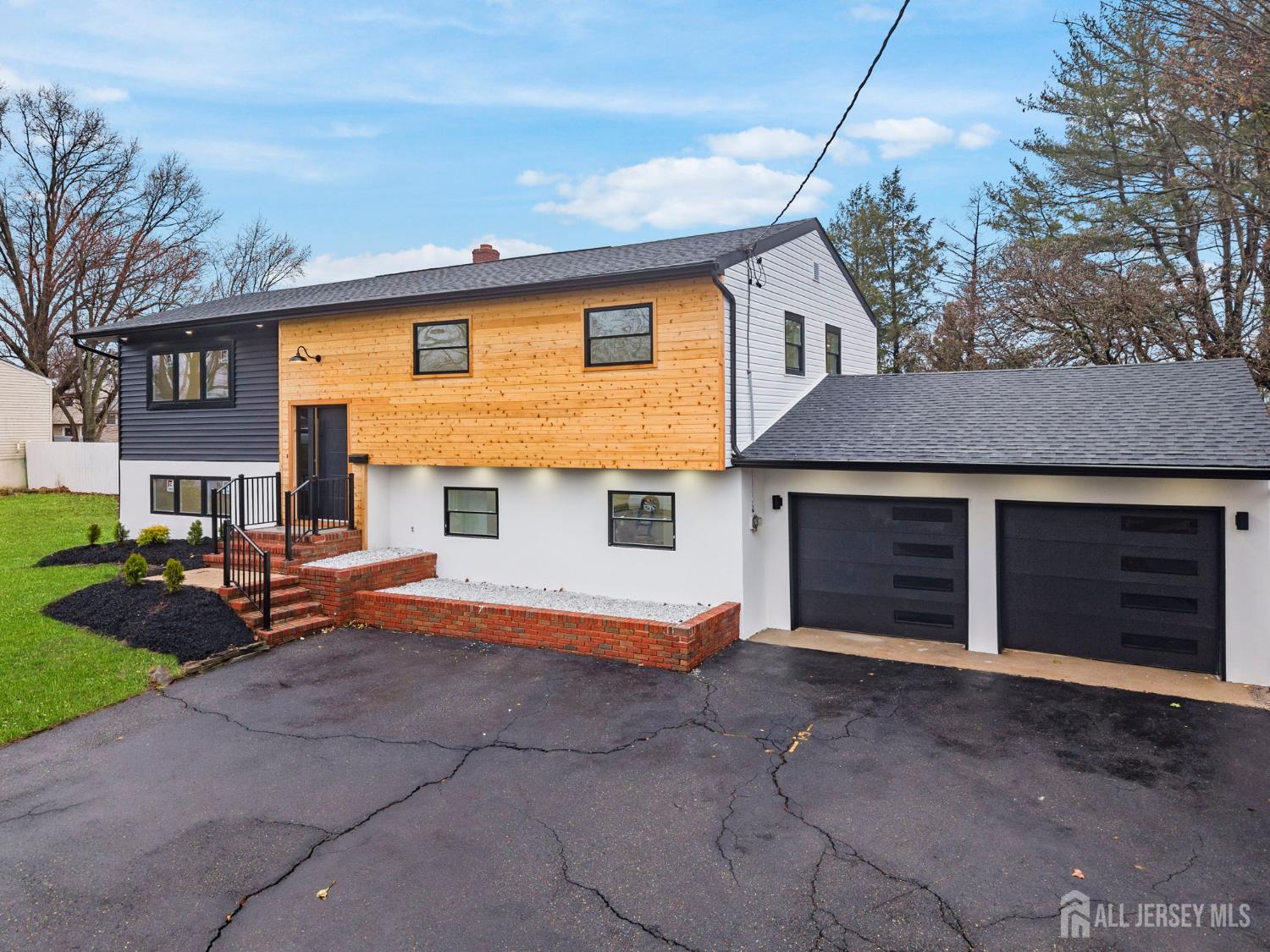 12 Barker Road Somerset, NJ 08873 - Photo 38 of 43 a front view of a house with yard and parking space