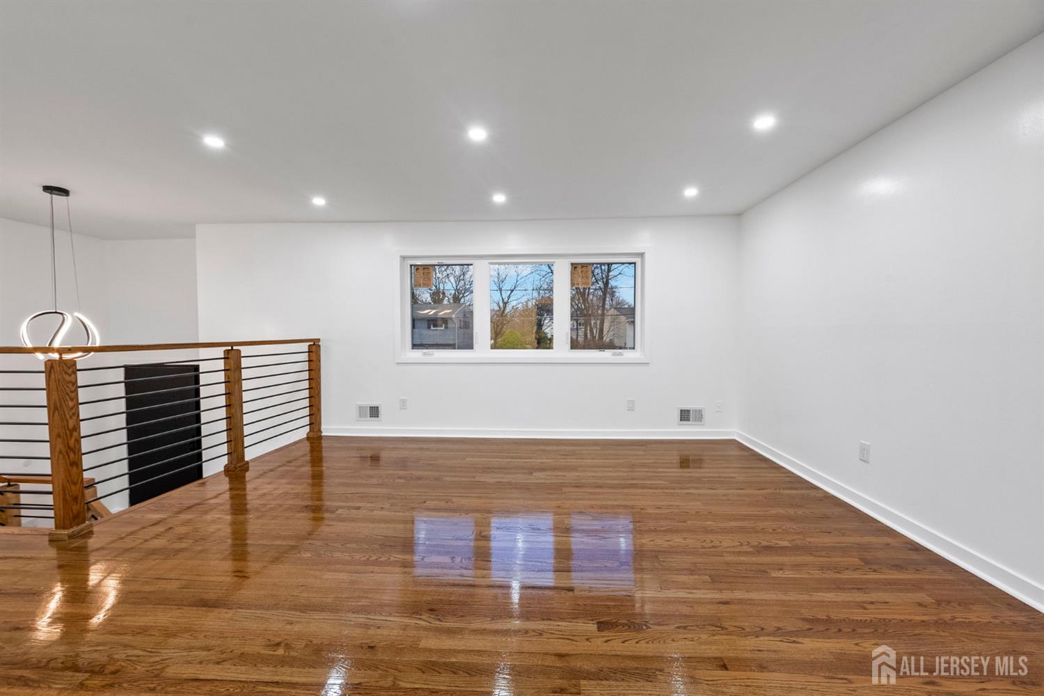 12 Barker Road Somerset, NJ 08873 - Photo 4 of 43 a view of an empty room with wooden floor and a window