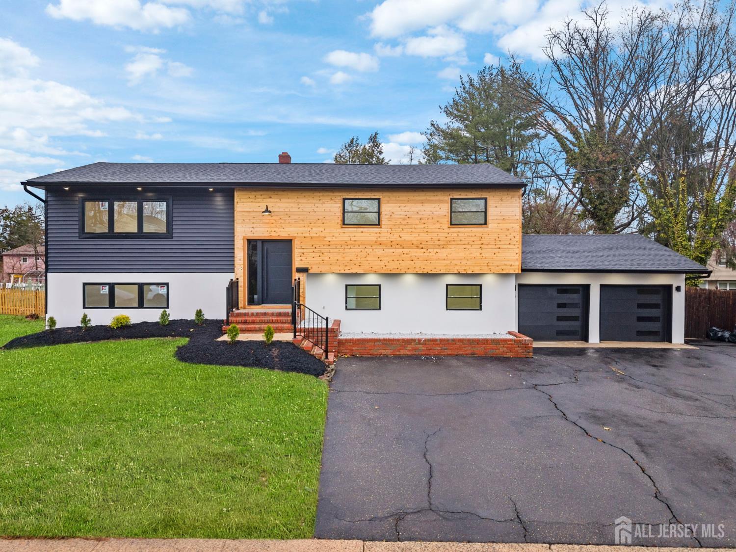 12 Barker Road Somerset, NJ 08873 - Photo 43 of 43 a front view of a house with a yard and garage