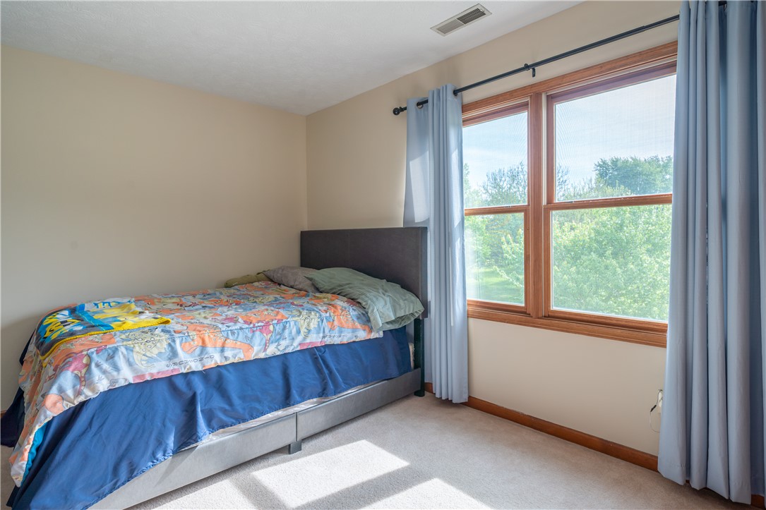 3628 Petre Road Springfield, OH 45502 - Photo 22 of 52 This sunlit bedroom features carpeted floors and large windows.
