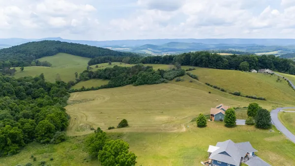 an aerial view of a houses with outdoor space