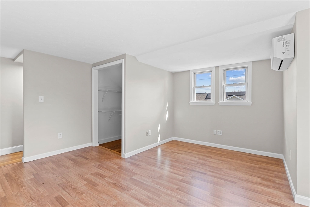 9 Home Avenue, Unit 2 Natick, MA 01760 - Photo 12 of 19 a view of an empty room with wooden floor and a window