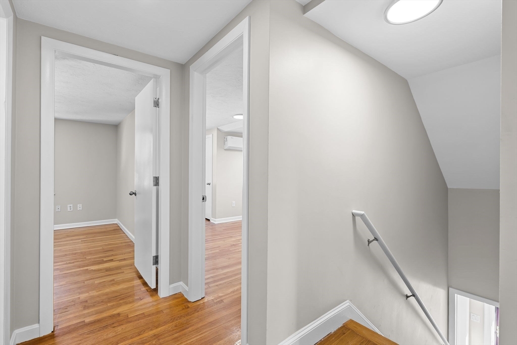 9 Home Avenue, Unit 2 Natick, MA 01760 - Photo 13 of 19 a view of a hallway with wooden floor