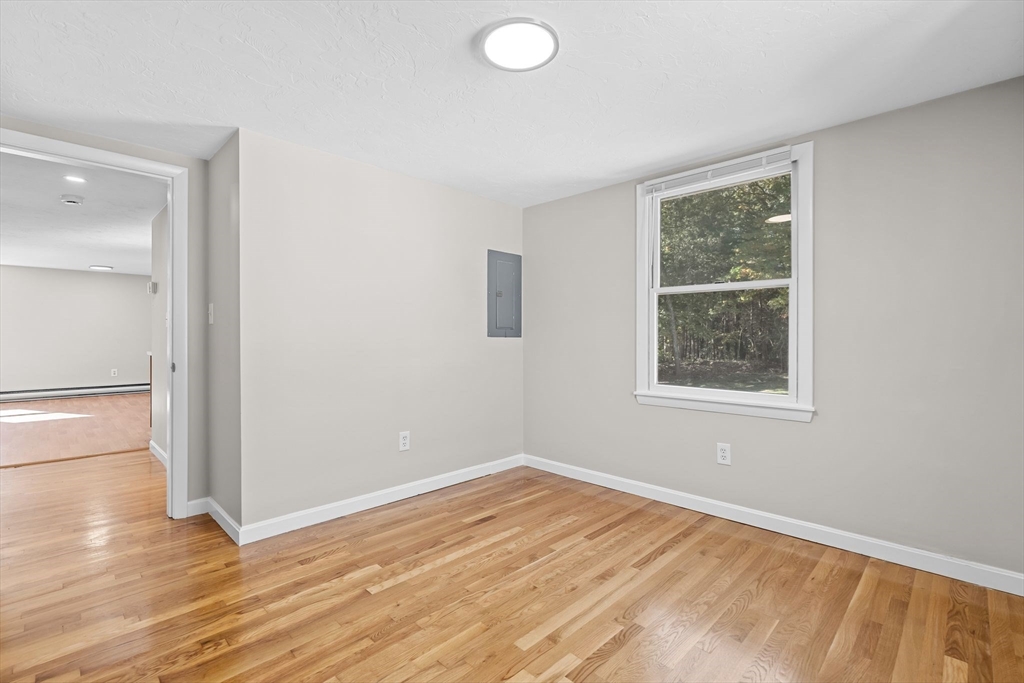 9 Home Avenue, Unit 2 Natick, MA 01760 - Photo 16 of 19 an empty room with wooden floor and windows