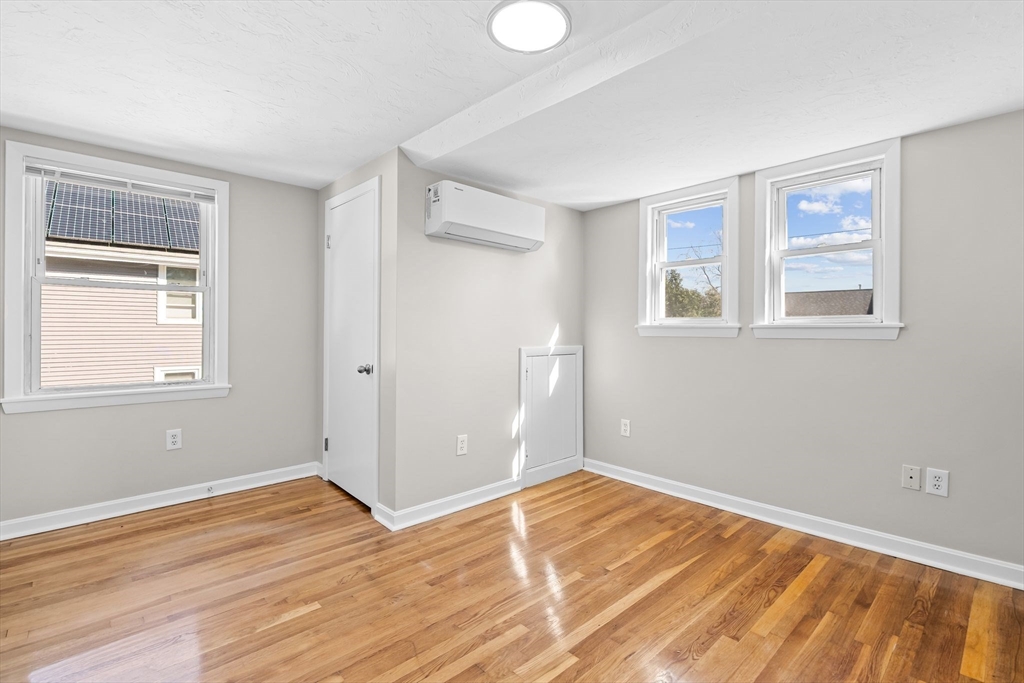 9 Home Avenue, Unit 2 Natick, MA 01760 - Photo 17 of 19 a view of empty room with wooden floor and fan
