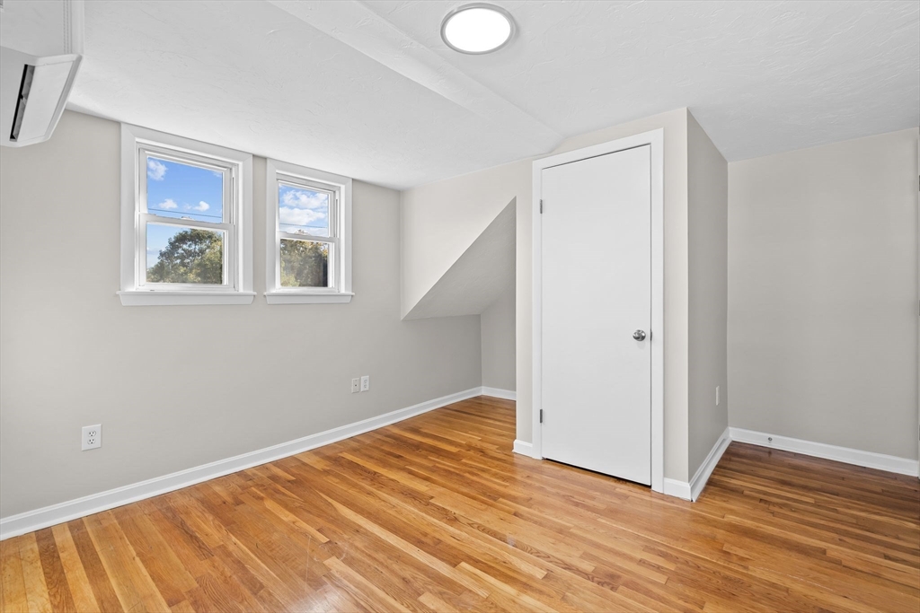 9 Home Avenue, Unit 2 Natick, MA 01760 - Photo 18 of 19 a view of an empty room with wooden floor and a window