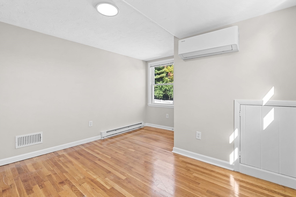 9 Home Avenue, Unit 2 Natick, MA 01760 - Photo 19 of 19 a view of an empty room with wooden floor and a window