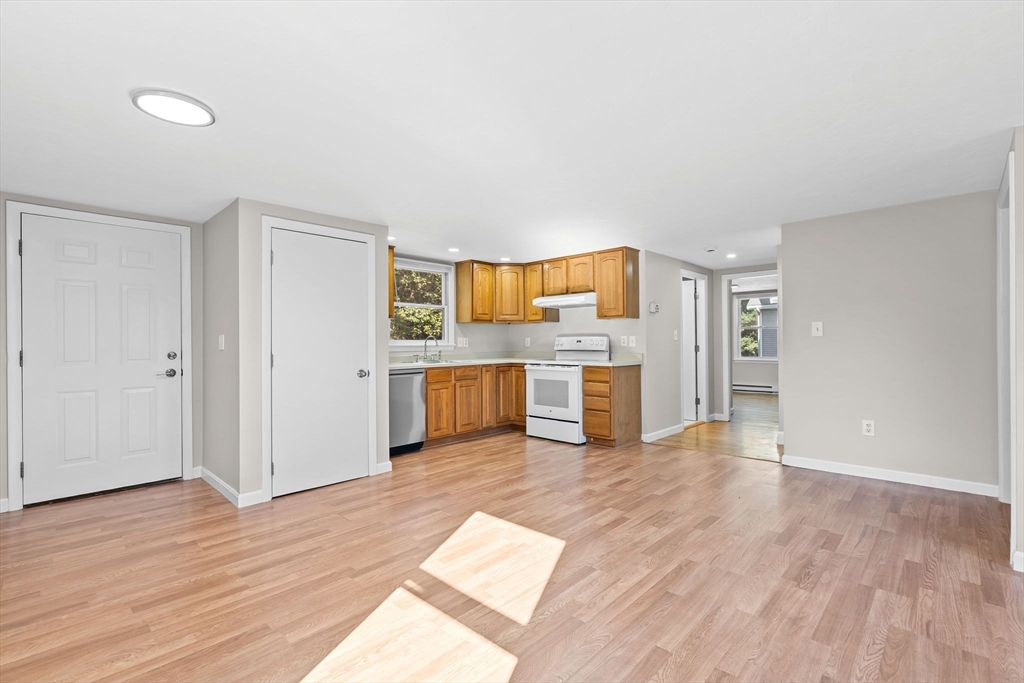 9 Home Avenue, Unit 2 Natick, MA 01760 - Photo 5 of 19 a view of a kitchen with a sink and a refrigerator