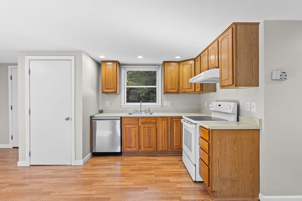 9 Home Avenue, Unit 2 Natick, MA 01760 - Photo 8 of 19 a kitchen with stainless steel appliances granite countertop a sink stove and refrigerator