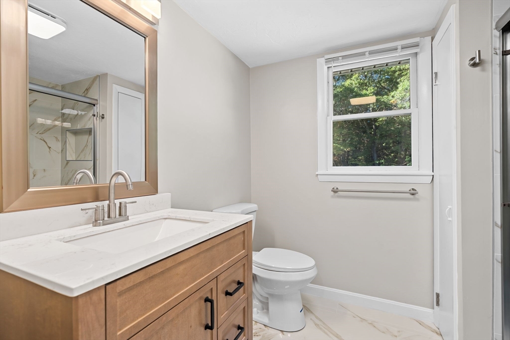 9 Home Avenue, Unit 2 Natick, MA 01760 - Photo 9 of 19 a bathroom with a sink a toilet and a window