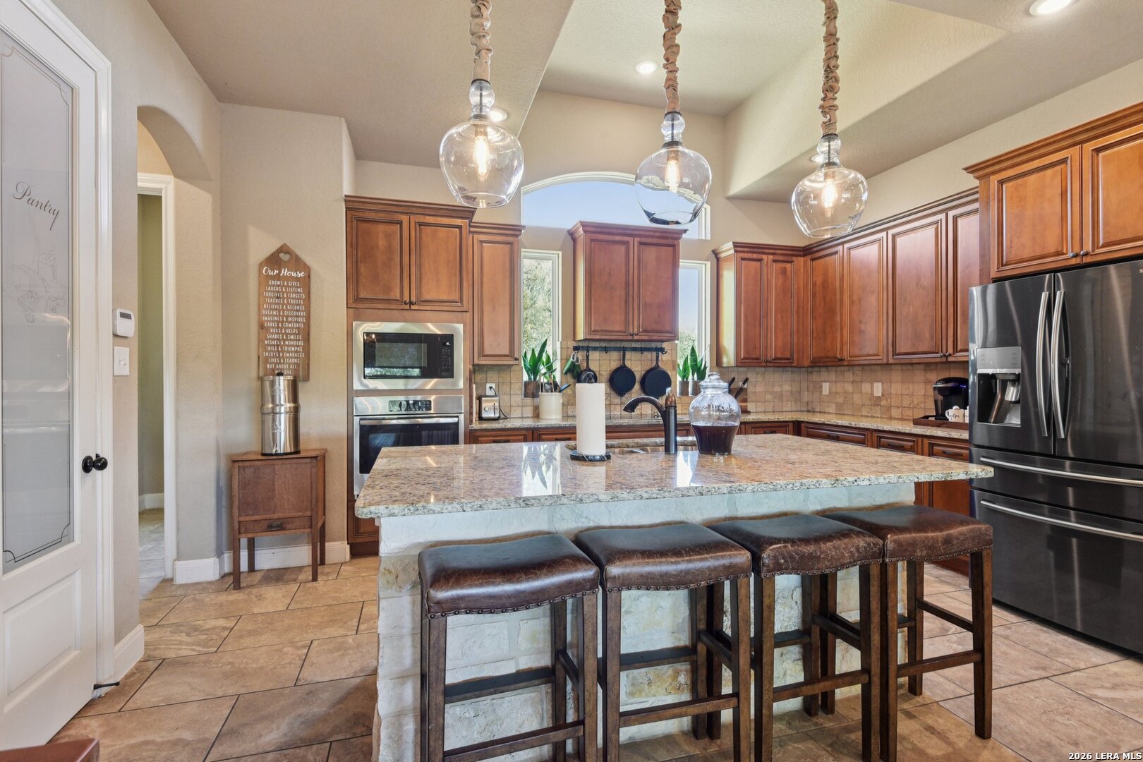 345 Ridge Point Spring Branch, TX 78070 - Photo 15 of 48 a kitchen with refrigerator cabinets dining table and chairs