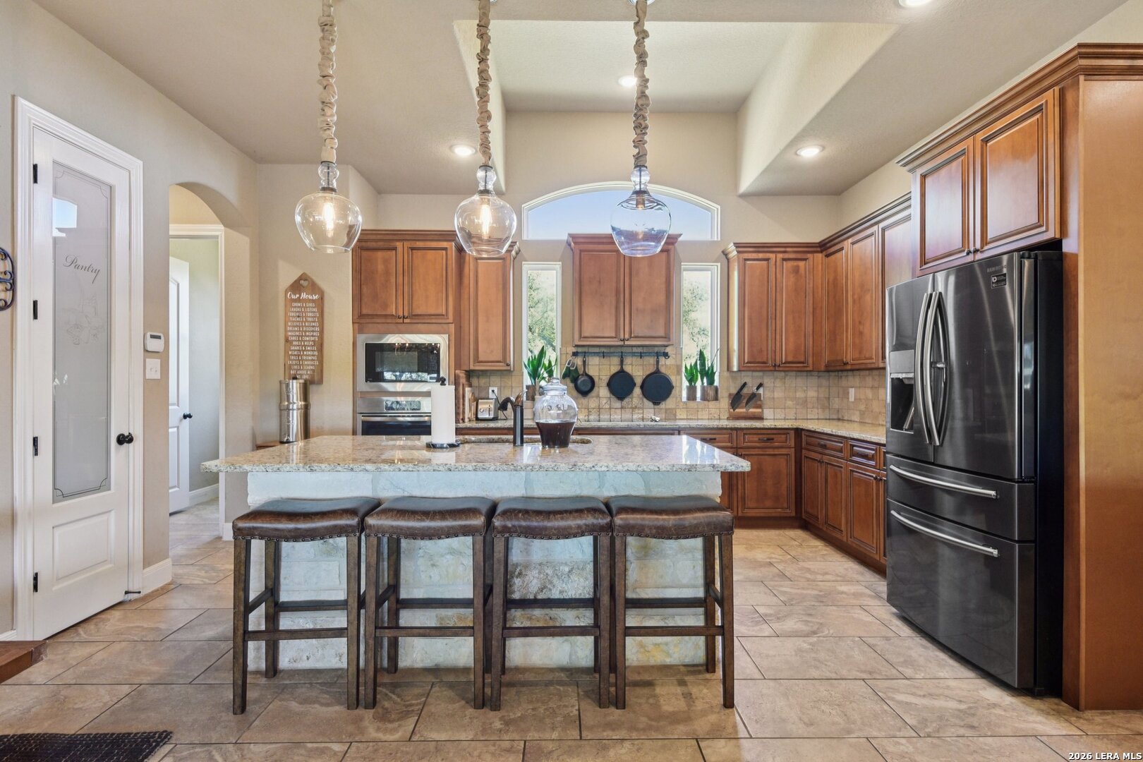 345 Ridge Point Spring Branch, TX 78070 - Photo 16 of 48 a kitchen with granite countertop a table chairs stainless steel appliances and cabinets
