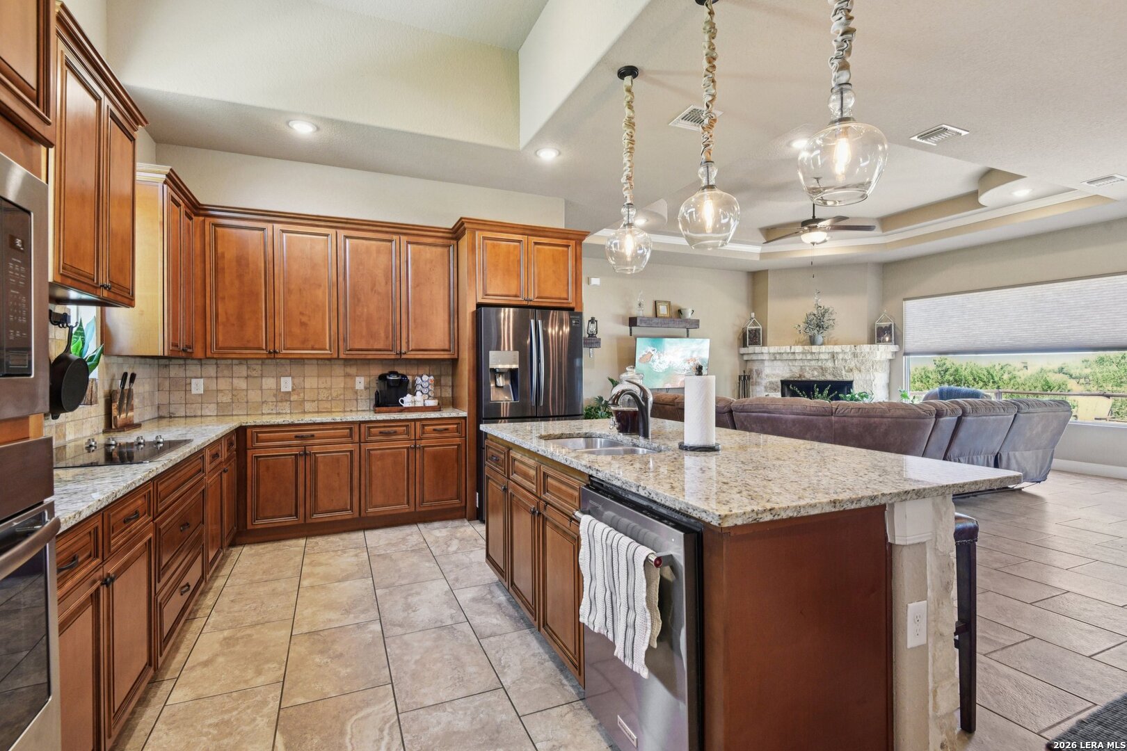 345 Ridge Point Spring Branch, TX 78070 - Photo 17 of 48 a kitchen with stainless steel appliances granite countertop a sink counter space cabinets and a large window