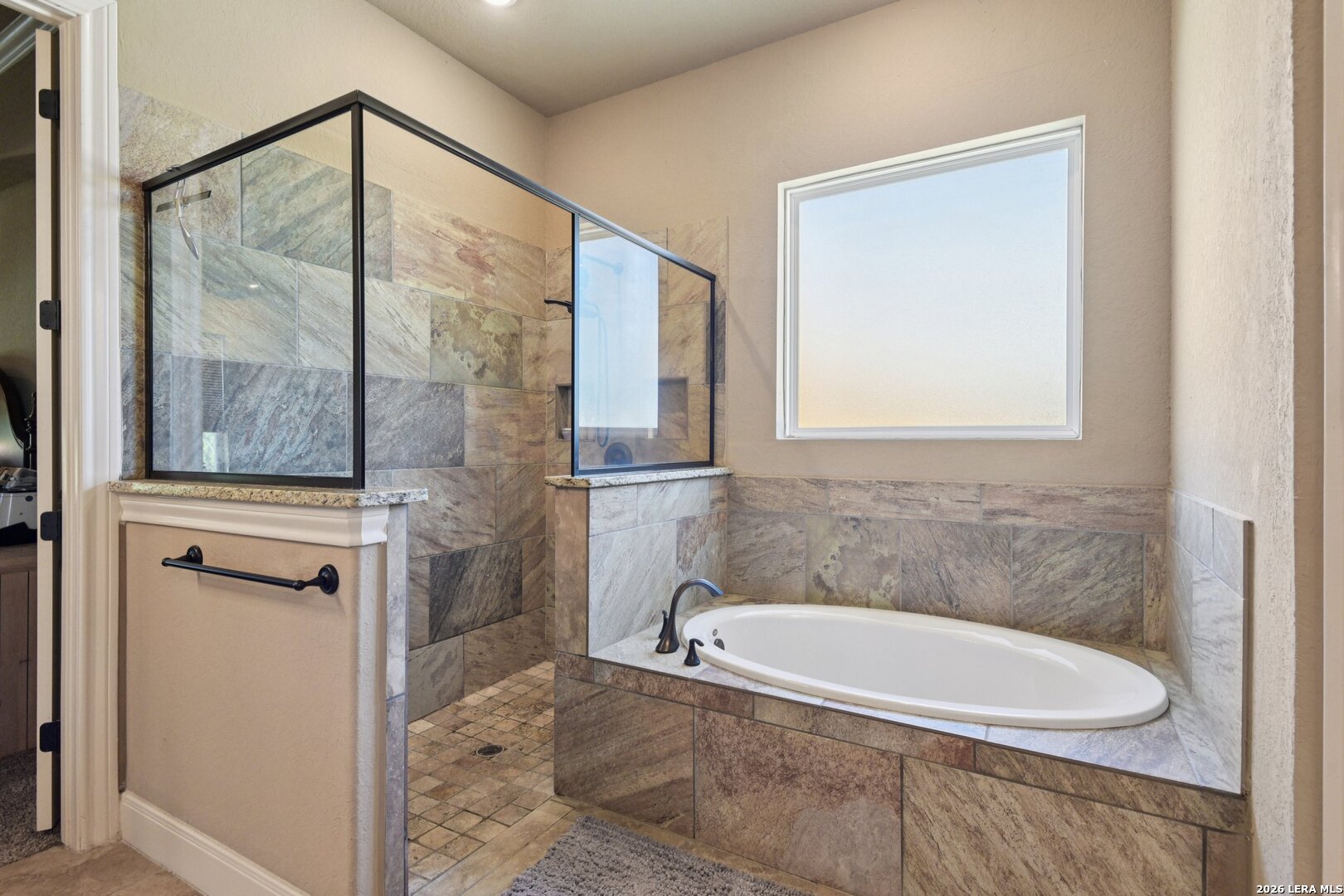 345 Ridge Point Spring Branch, TX 78070 - Photo 22 of 48 a bathroom with a granite countertop bathtub a shower and a sink