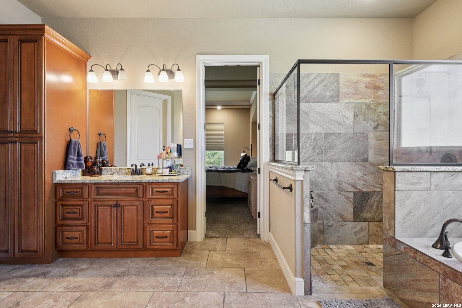 345 Ridge Point Spring Branch, TX 78070 - Photo 25 of 48 a bathroom with a granite countertop sink a mirror and shower