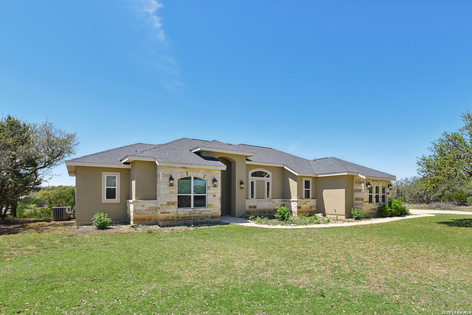 345 Ridge Point Spring Branch, TX 78070 - Photo 3 of 48 a front view of a house with a garden