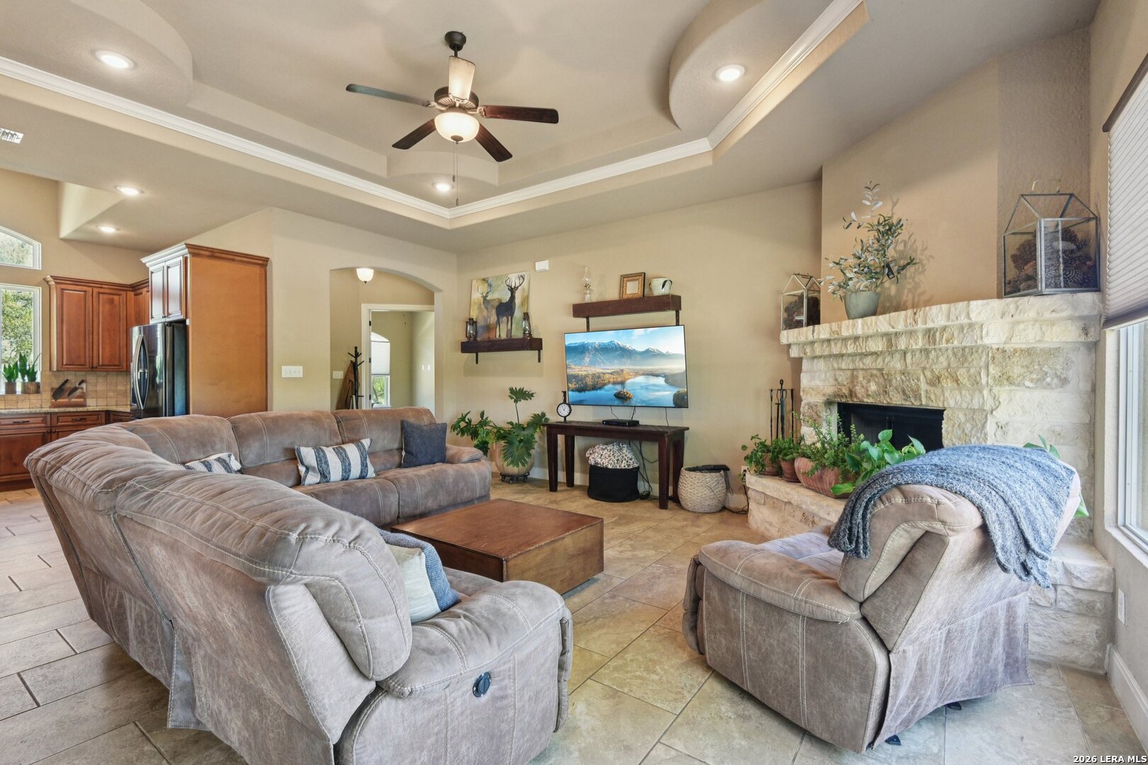 345 Ridge Point Spring Branch, TX 78070 - Photo 9 of 48 a living room with furniture a fireplace and a ceiling fan