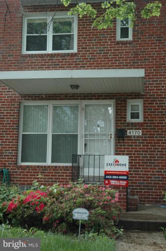 4170 Crest Heights Road Baltimore, MD 21215 - Photo 11 of 30 a front view of a house with a yard