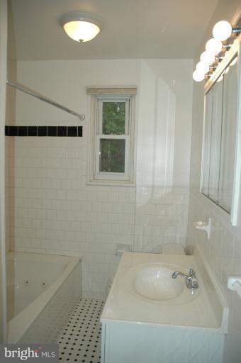 4170 Crest Heights Road Baltimore, MD 21215 - Photo 12 of 30 a bathroom with a shower and a bathtub