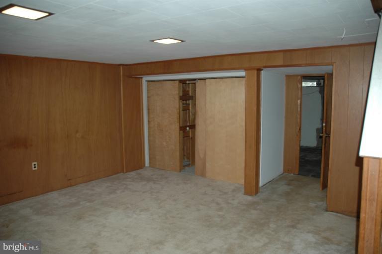 4170 Crest Heights Road Baltimore, MD 21215 - Photo 26 of 30 an empty room with closet and wooden door