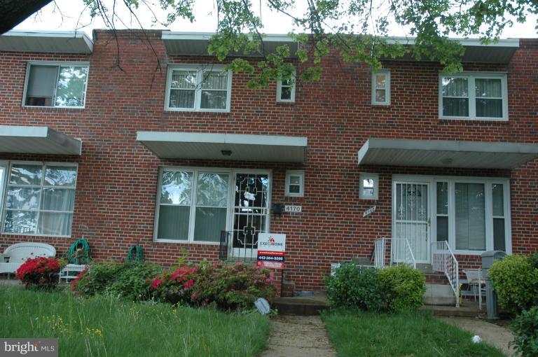 4170 Crest Heights Road Baltimore, MD 21215 - Photo 30 of 30 a view of a brick house with a flower garden